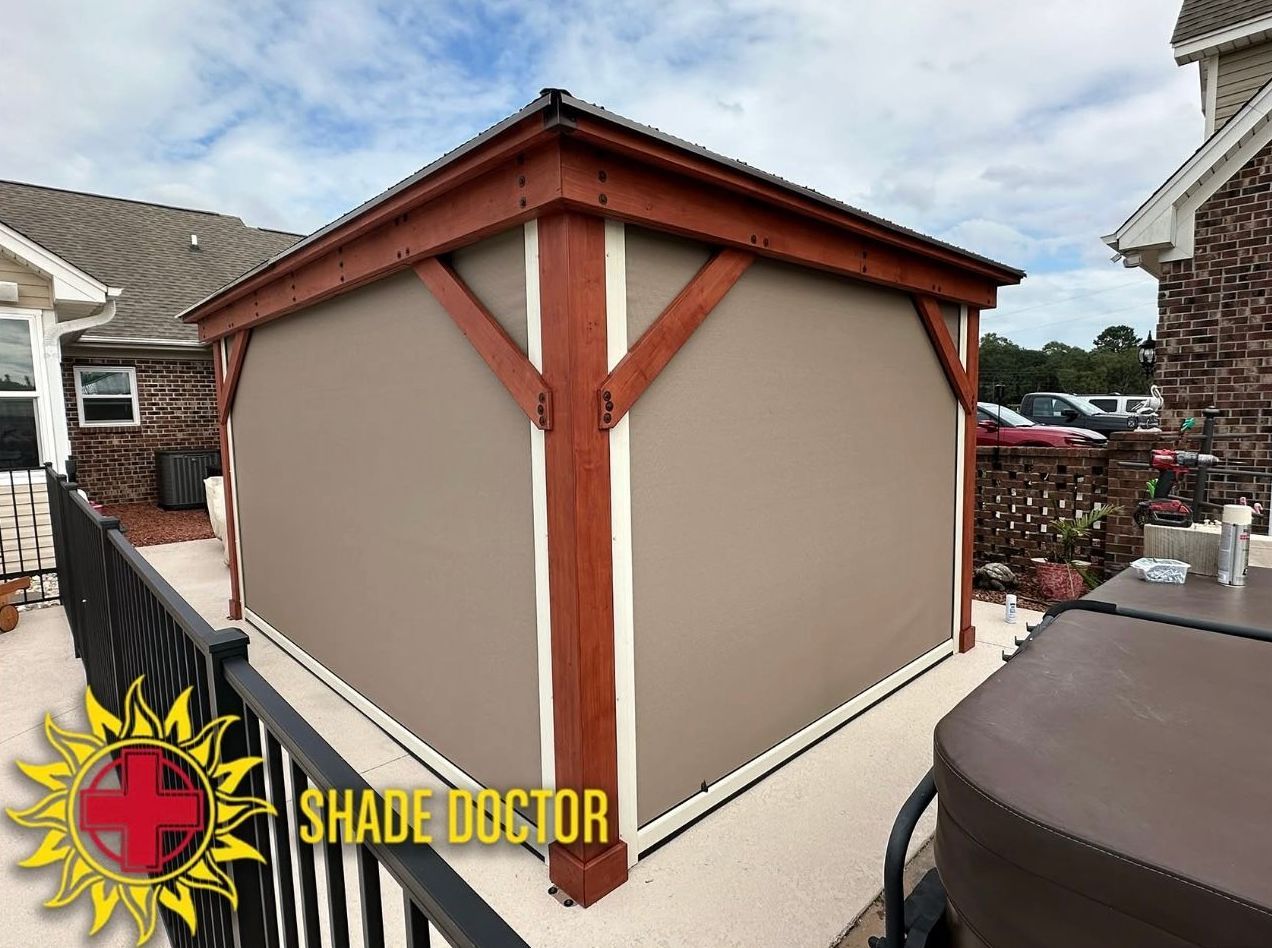 Brown gazebo enclosure with red trim on a rooftop deck, Shade Doctor logo in the corner