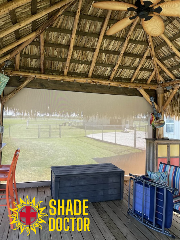 Thatched-roof pavilion with shade over a grassy area and benches, featuring a “Shade Doctor” logo.