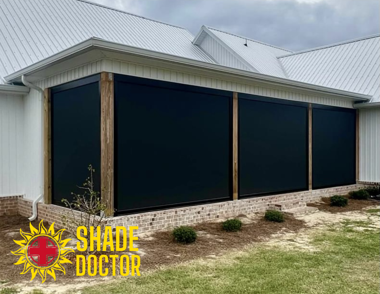 House exterior with black outdoor roller shades covering windows under a white roof