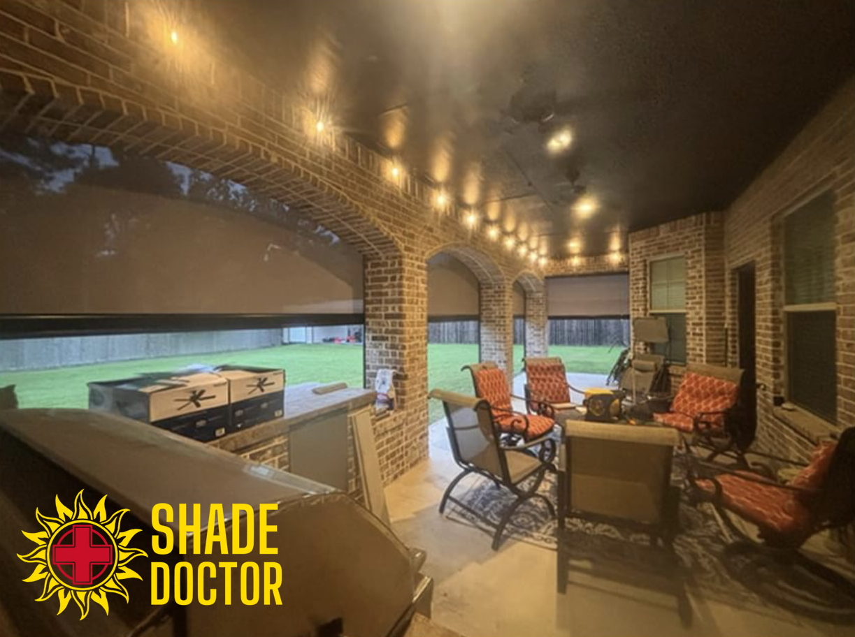Brick outdoor patio with covered seating, ceiling lights, and a view of a pool and grassy field