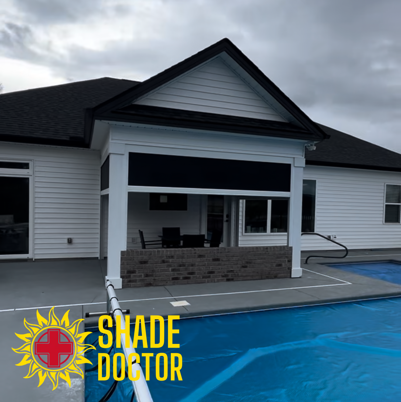 White house with covered patio and blue pool, featuring a Shade Doctor logo in the lower left.