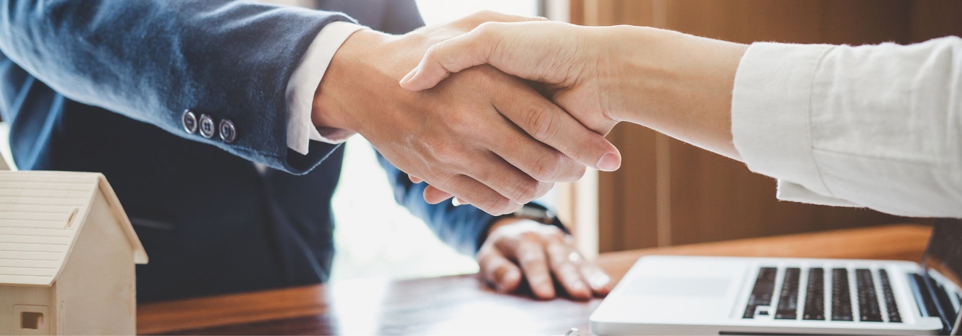 real estate agent shaking hands with client