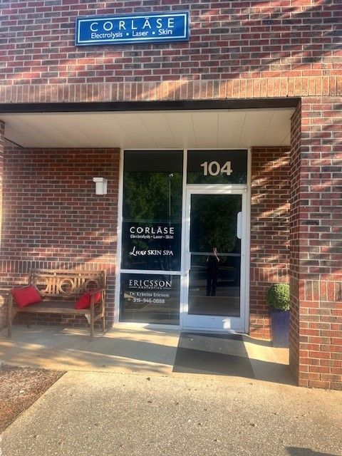 A brick building with the number 104 on the door