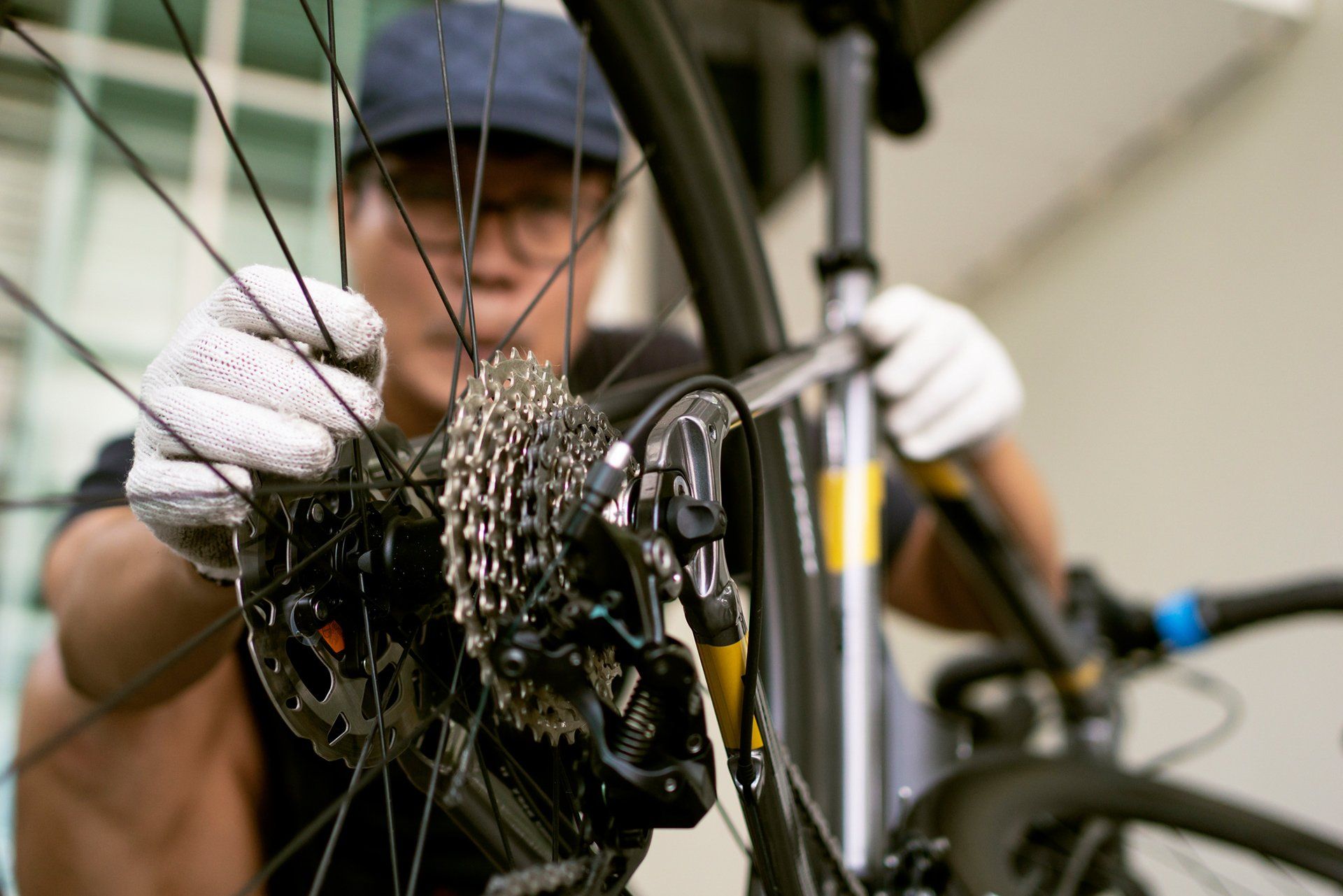 Mechanic Repairing Bicycle Break — Columbia, MO — Jim's Bike & Key Shop Mechanic Repairing Bicycle Break — Columbia, MO — Jim's Bike & Key Shop