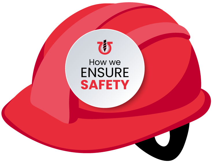 A red hard hat with a sticker that says how we ensure safety