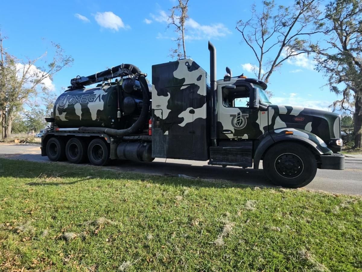 A black and white camouflage truck is parked on the side of the road.