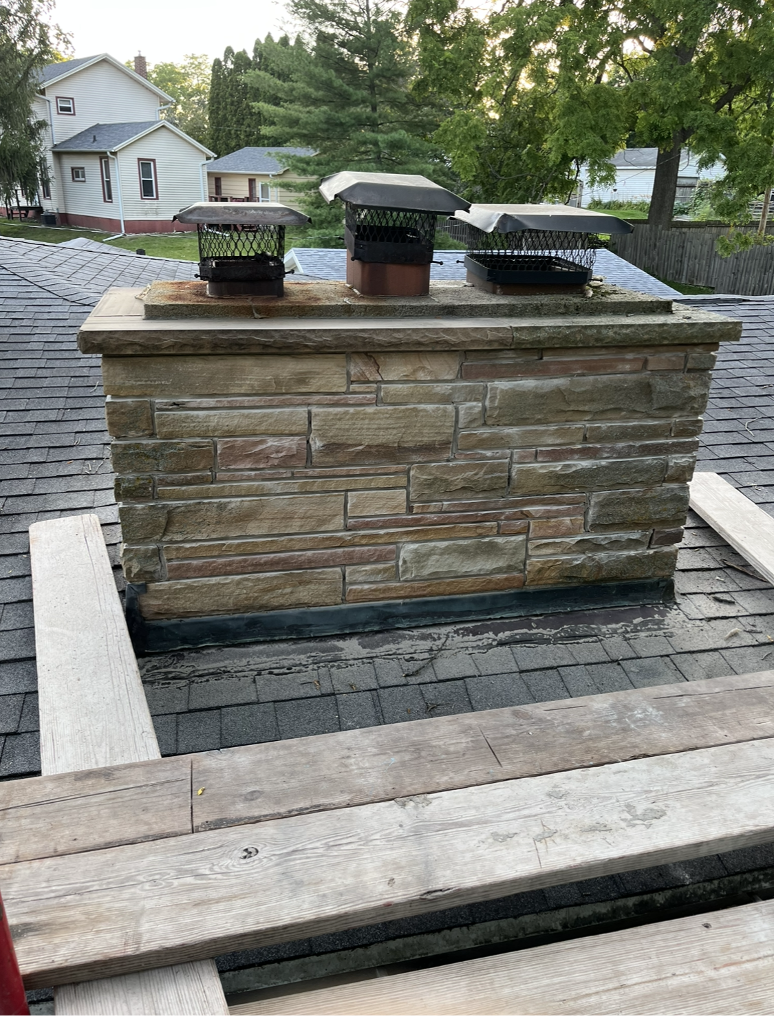 Chimney Pots — Rooftop View of a Variety of Different Chimney in Madison, Wisconsin