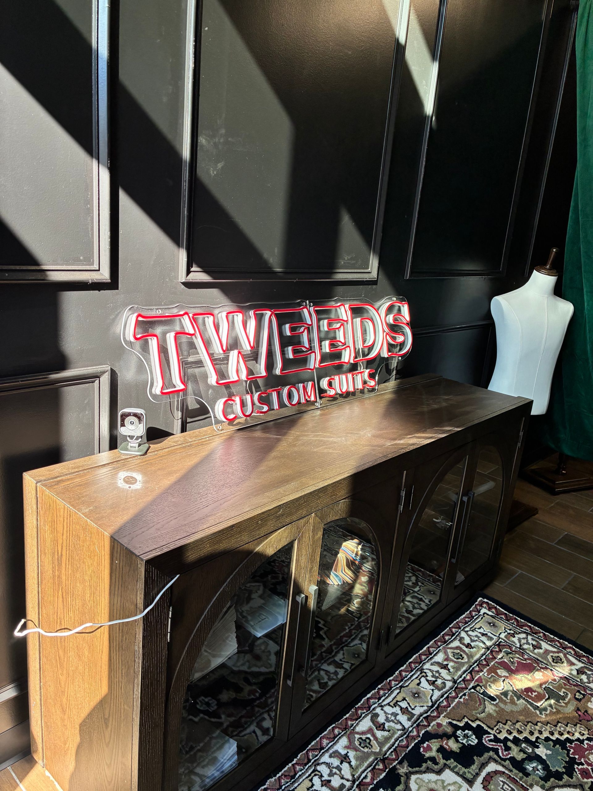 A wooden cabinet with a neon sign that says