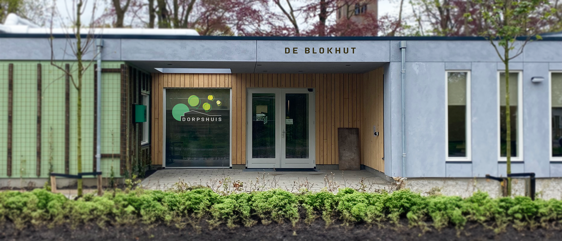 De voorkant van een gebouw met een bordje op het raam waarop staat 'wees blind'
