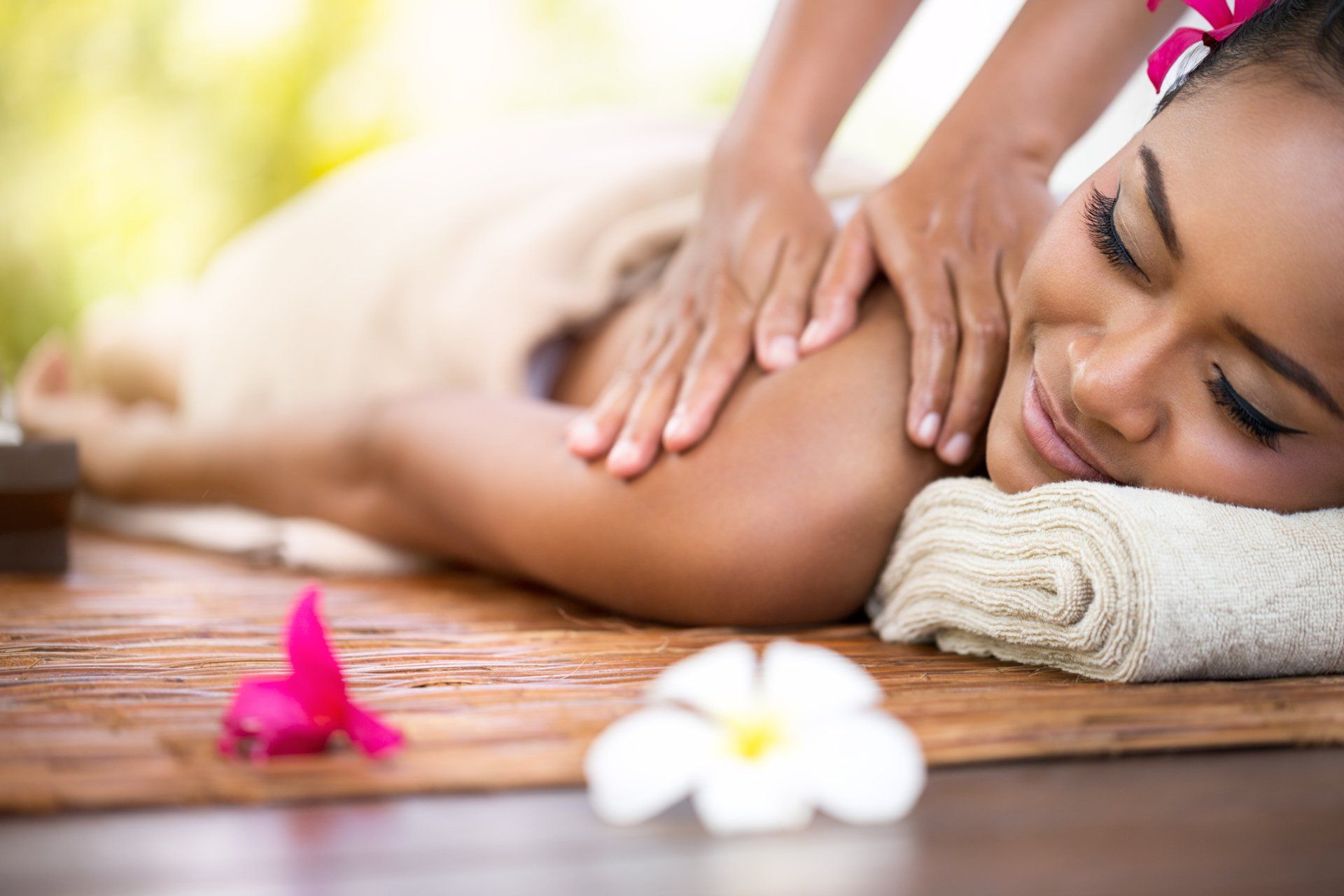 Woman relaxing during a professional massage treatment for summer self care and relaxatio