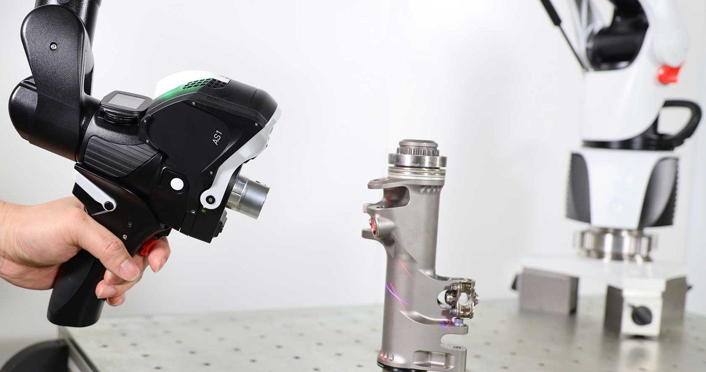 Handheld Hexagon laser scanner measuring a machined part