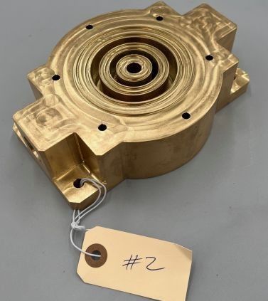 Brass-finished housing with inspection tag