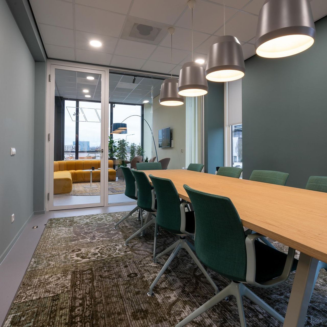 A conference room with a long table and chairs
