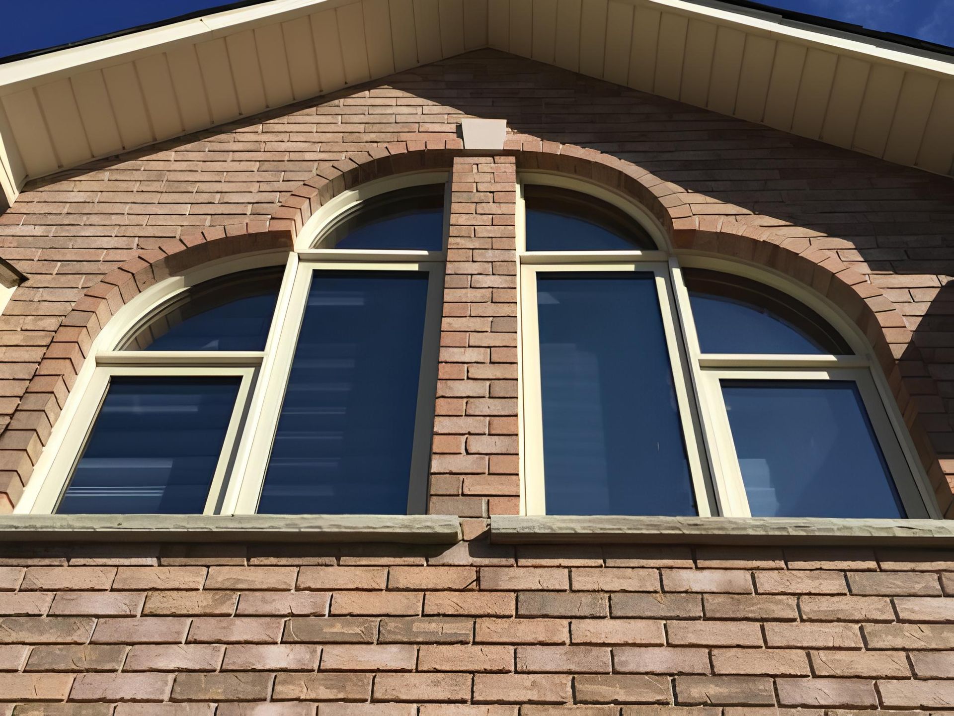 A brick building with arched windows on the side