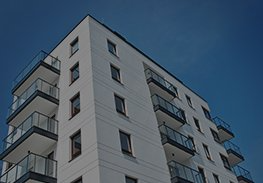 Modern apartment building with balconies against a clear blue sky
