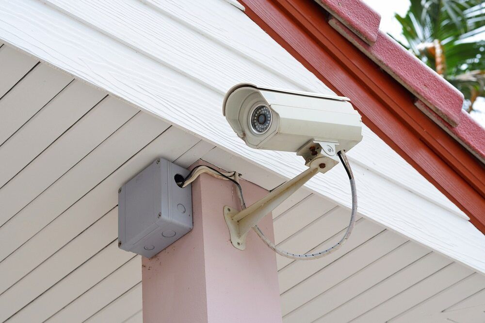 Security Camera Mounted on a Pink Pillar Under a White Roof — Flexicoms Communications in Ingham, QLD