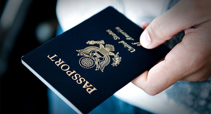 Hand holding a passport