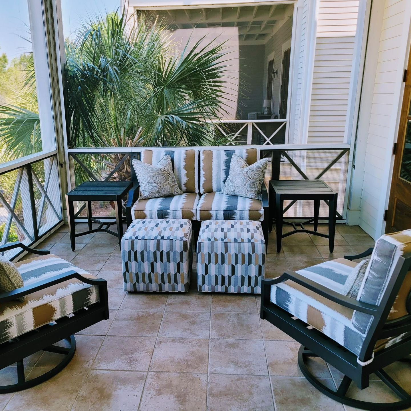 A screened in porch with a couch and chairs A screened in porch with a couch and chairs