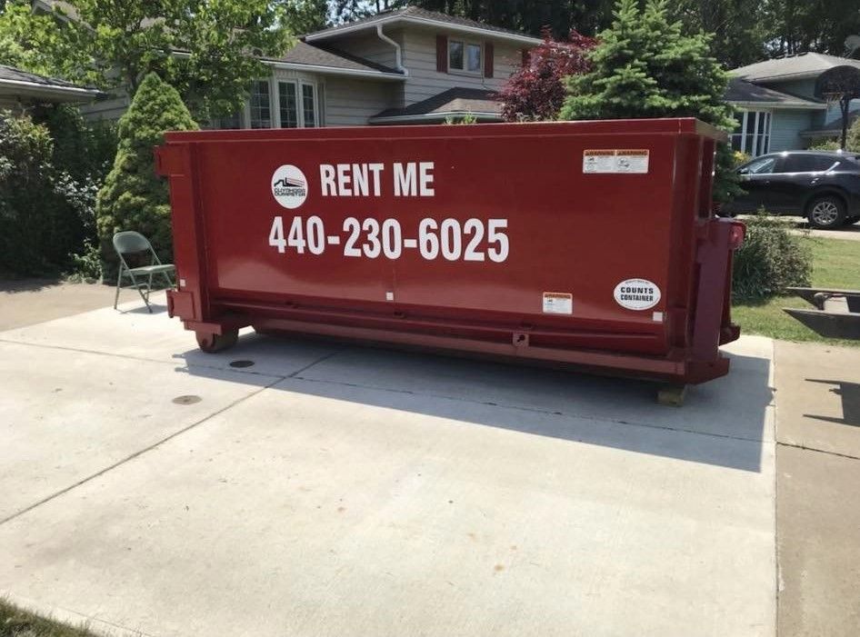 a red dumpster that says rent me on it