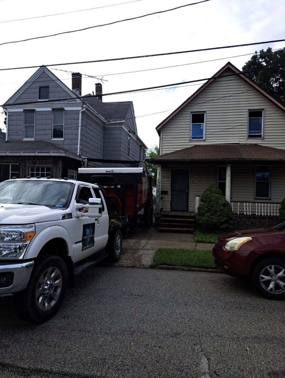a white truck is parked in front of a house