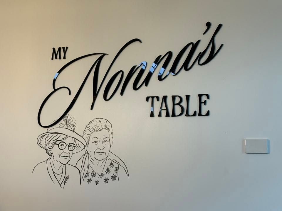 Wall Decal Reading with A Line Drawing of Two Elderly Women — Global Signage In Ingham, QLD