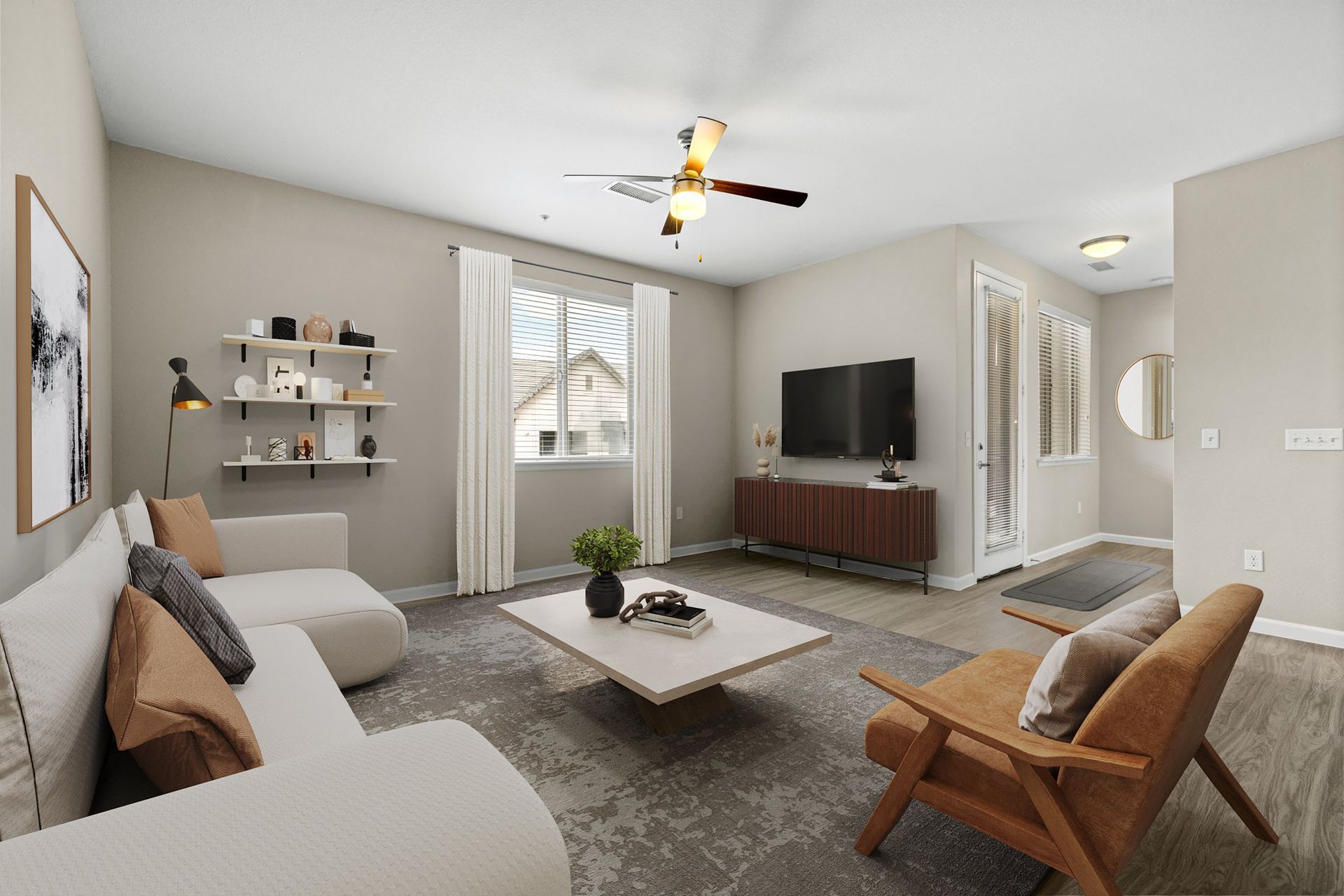 Living room with beige walls, white sofa, brown chair, coffee table, and TV at The Parc at Greenwood Village.