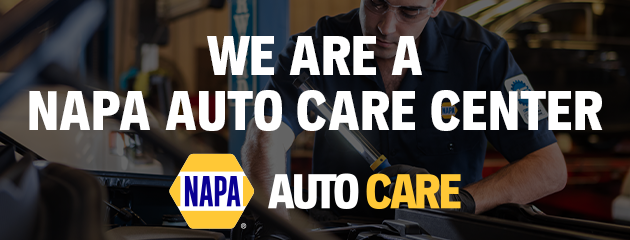 NAPA Auto Care Center banner with logo over a mechanic working on a car