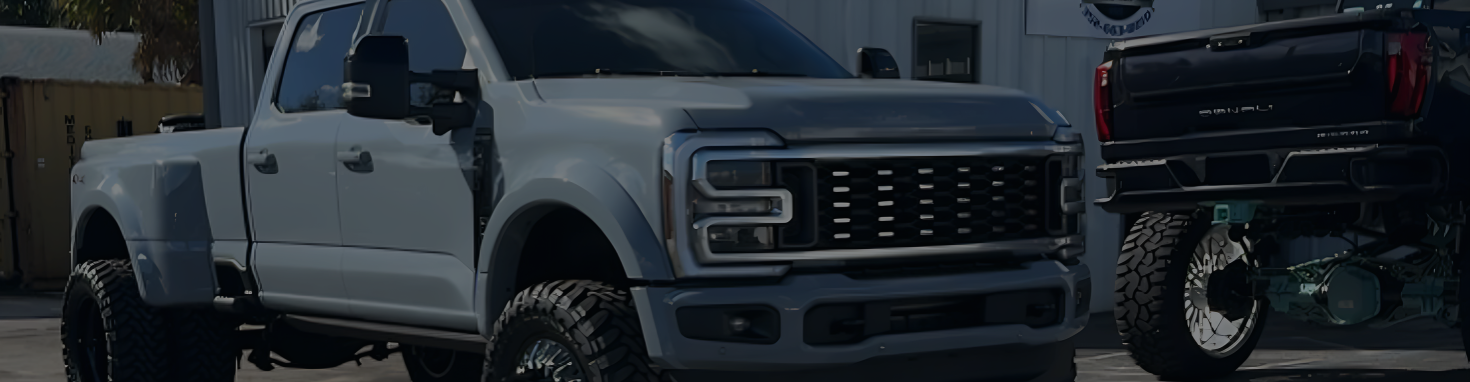 Black and white vehicles parked outside | DMR Diesel Repair, Inc
