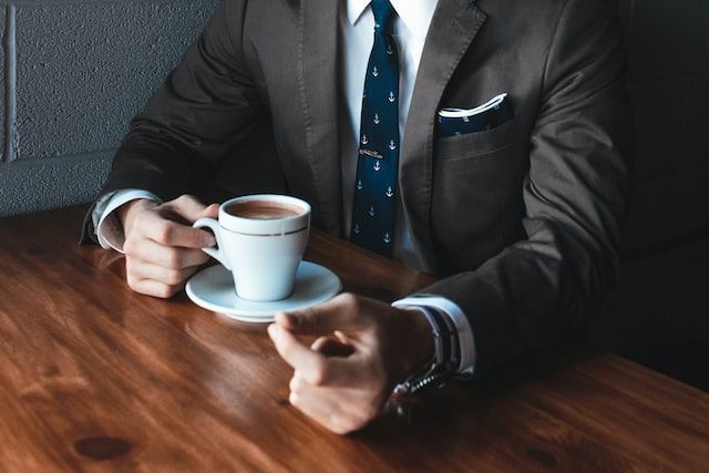 Funeral director consulting with a family over coffee to discuss funeral planning and end-of-life ar