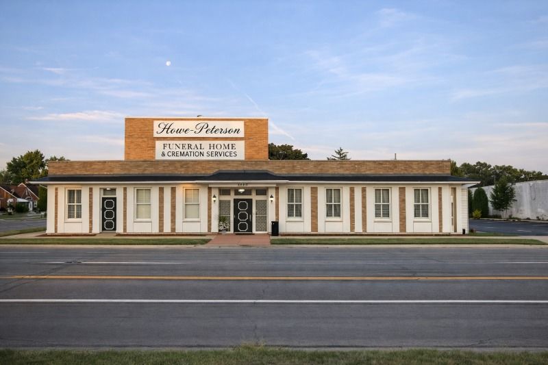 funeral home and cremations Lincoln Park, MI exterior with Howe-Peterson sign on brick facade and white columns.