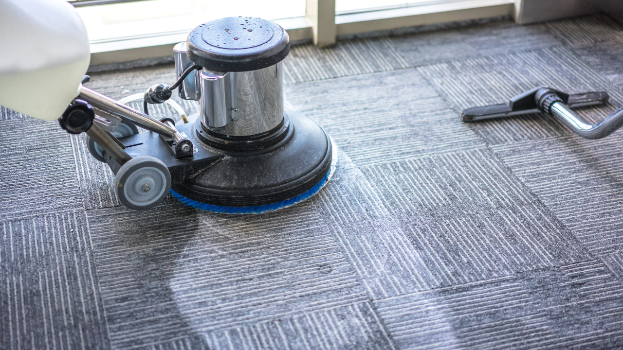 Professional carpet cleaning machine scrubbing commercial carpet for deep cleaning