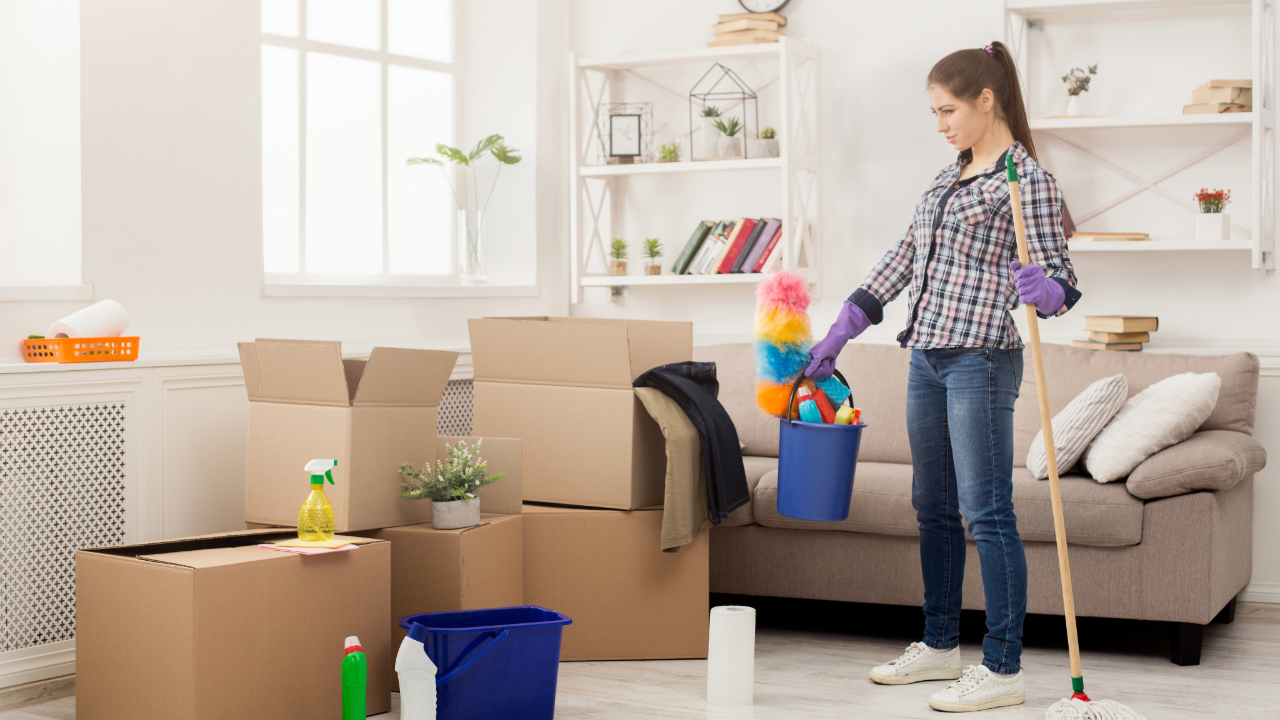 Professional cleaner preparing supplies for move out cleaning service in a tidy home