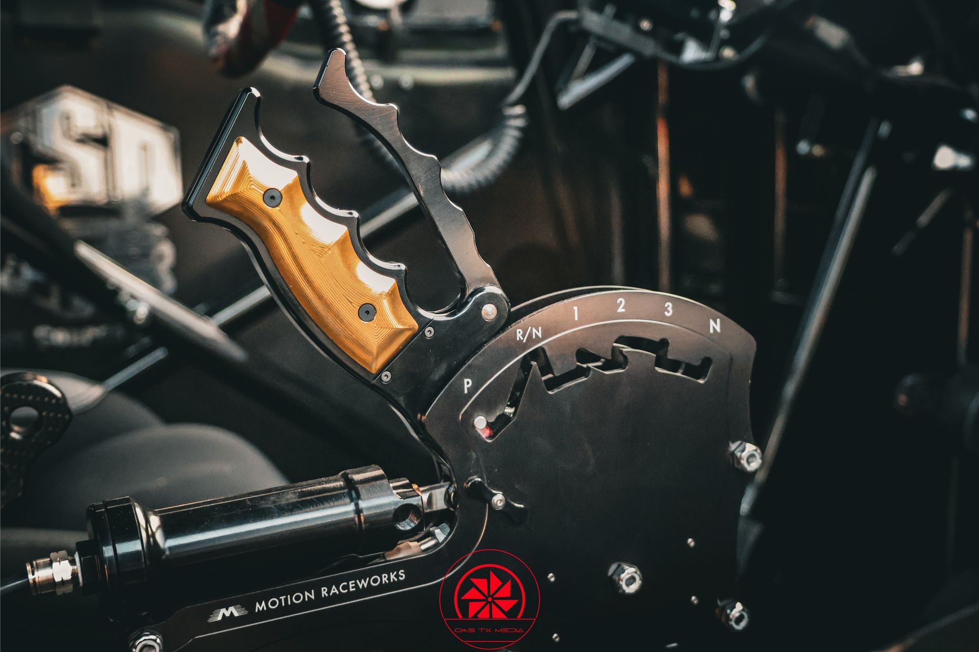 Close-up of a black motorcycle engine with an orange-handled knife mounted on it.