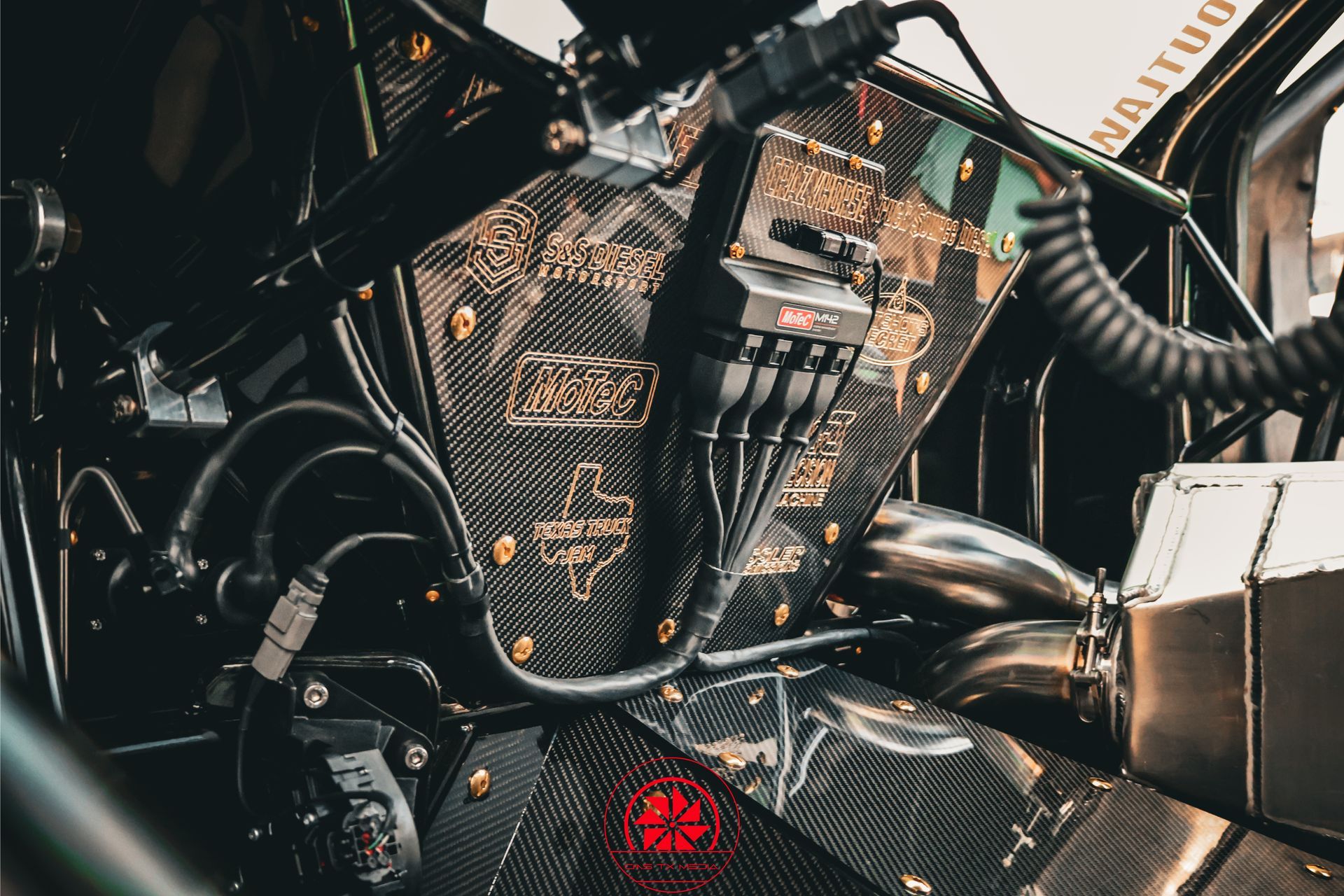 Close-up of a black motorcycle engine with chrome details and red taillight glow.