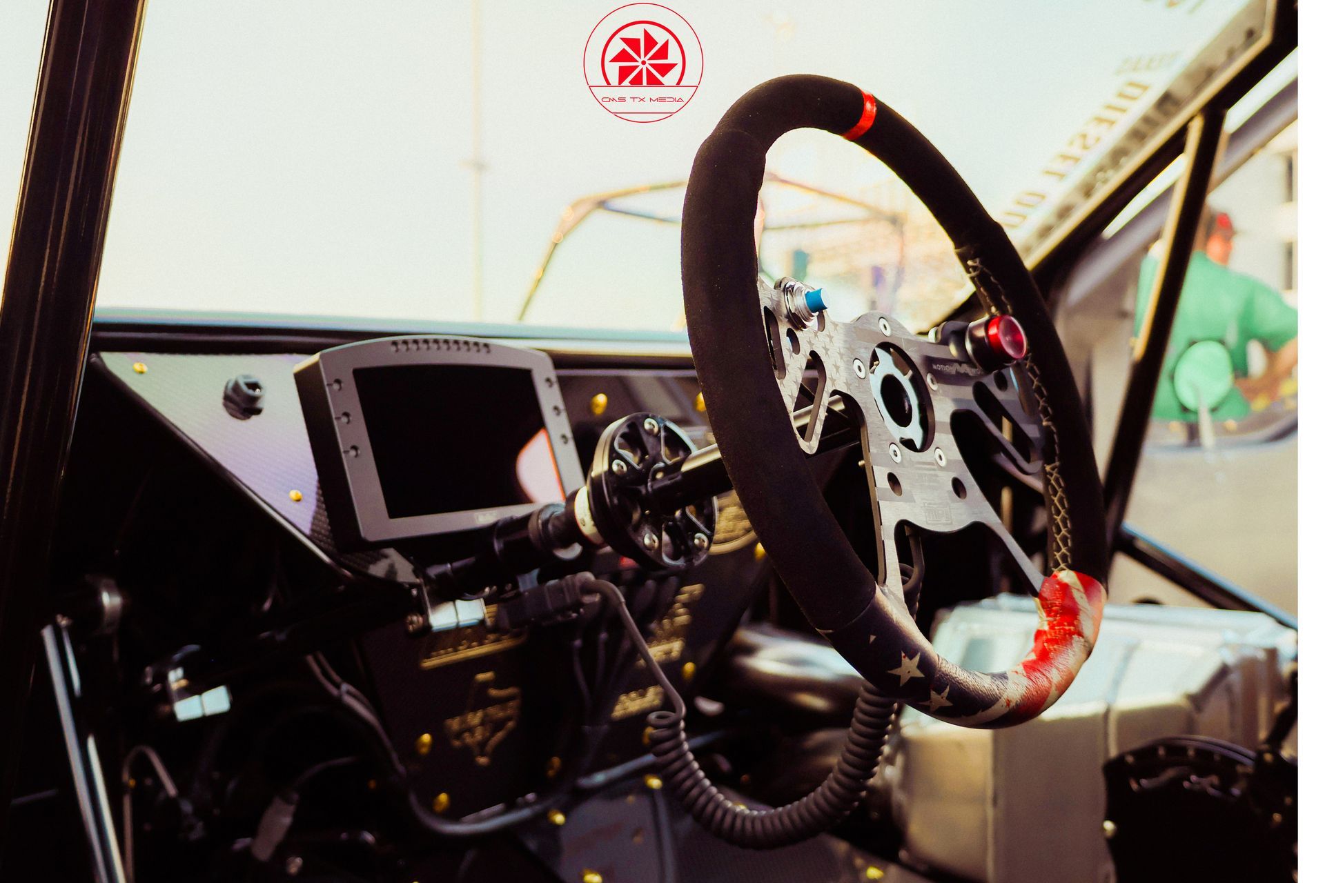 Rally car cockpit with steering wheel, dashboard, and roll cage interior view