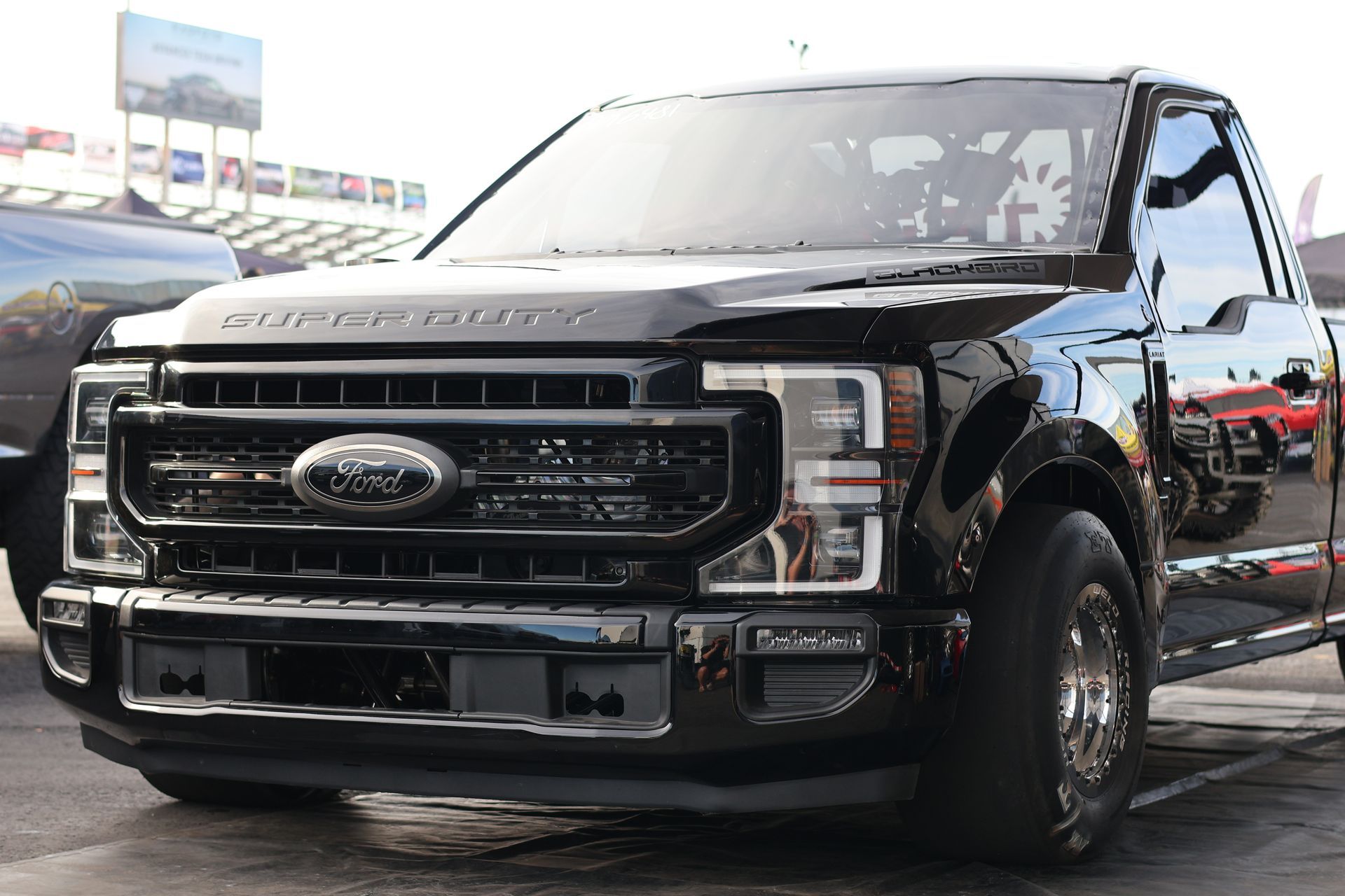 Black Ford pickup truck parked outdoors at a dealership lot.