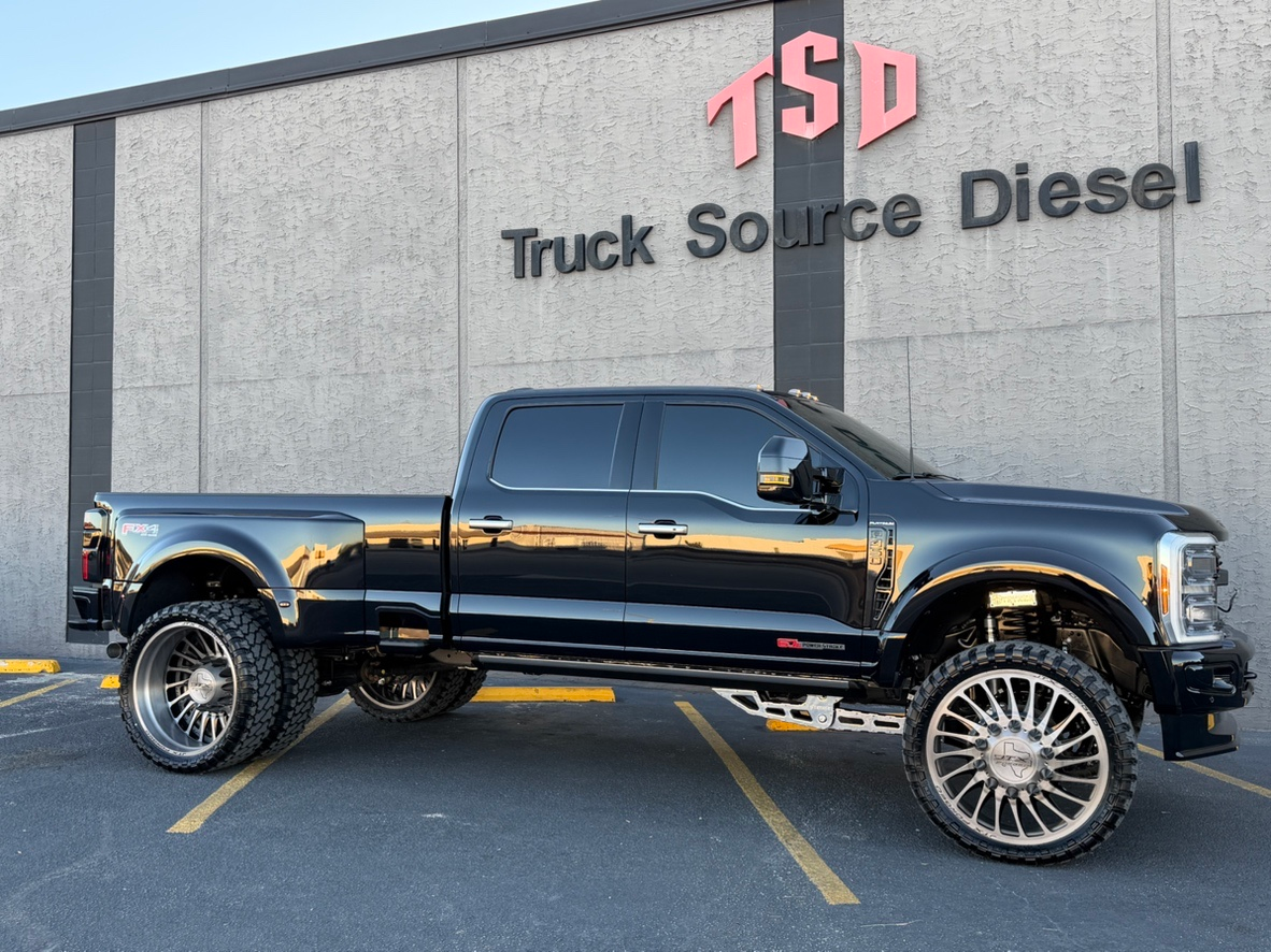 Black lifted pickup truck parked outside Truck Source Diesel building