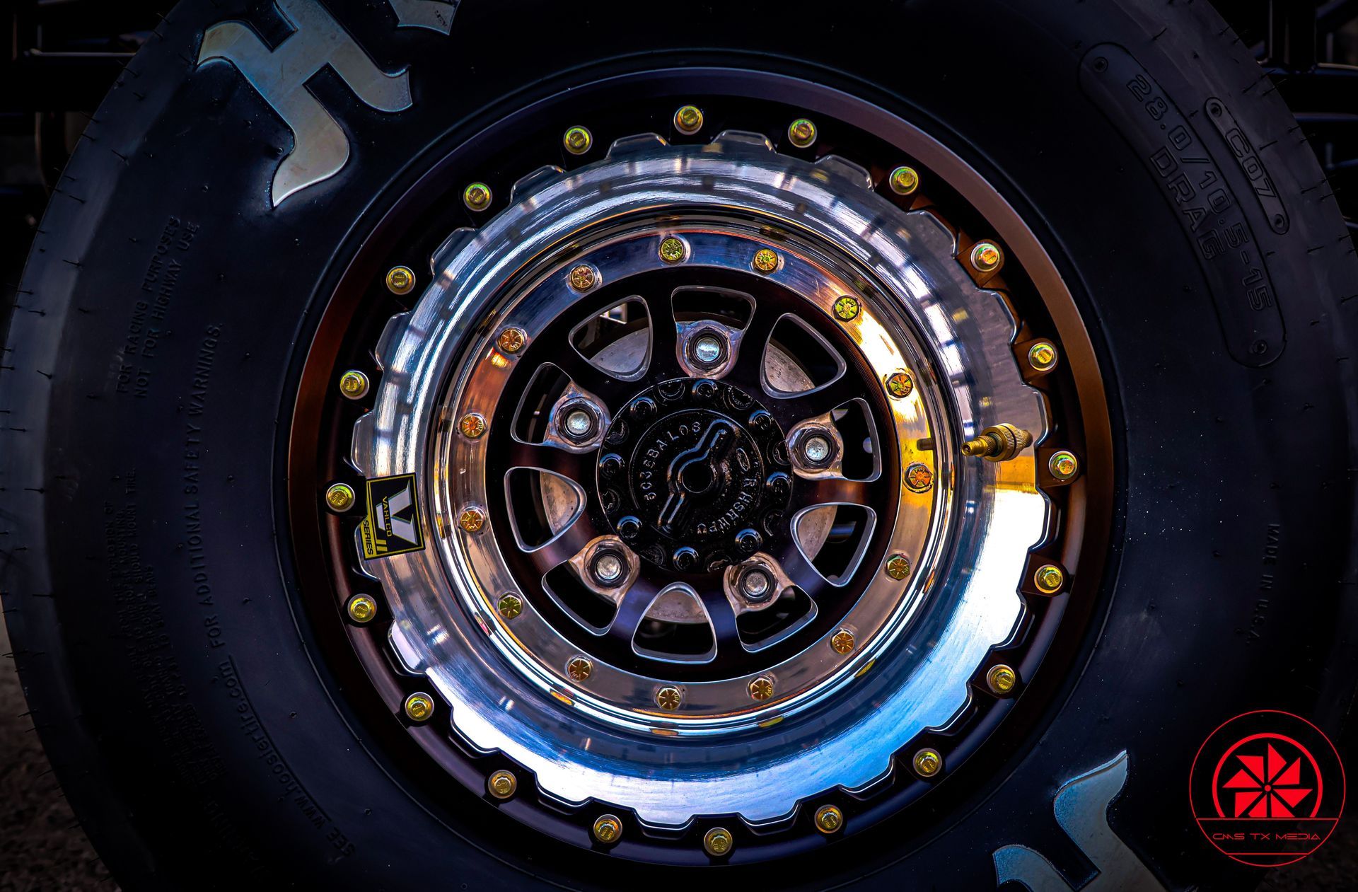 Close-up of a futuristic metallic wheel hub with glowing blue and gold accents on a dark background