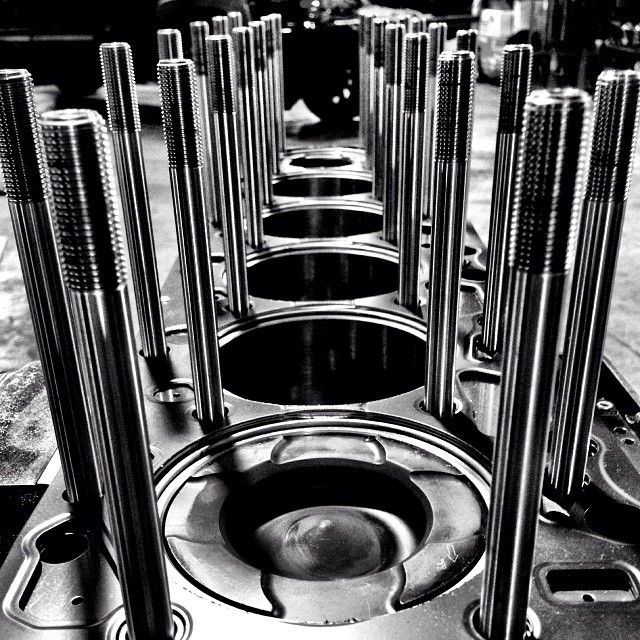 Close-up of shiny engine valves and springs in a mechanical assembly