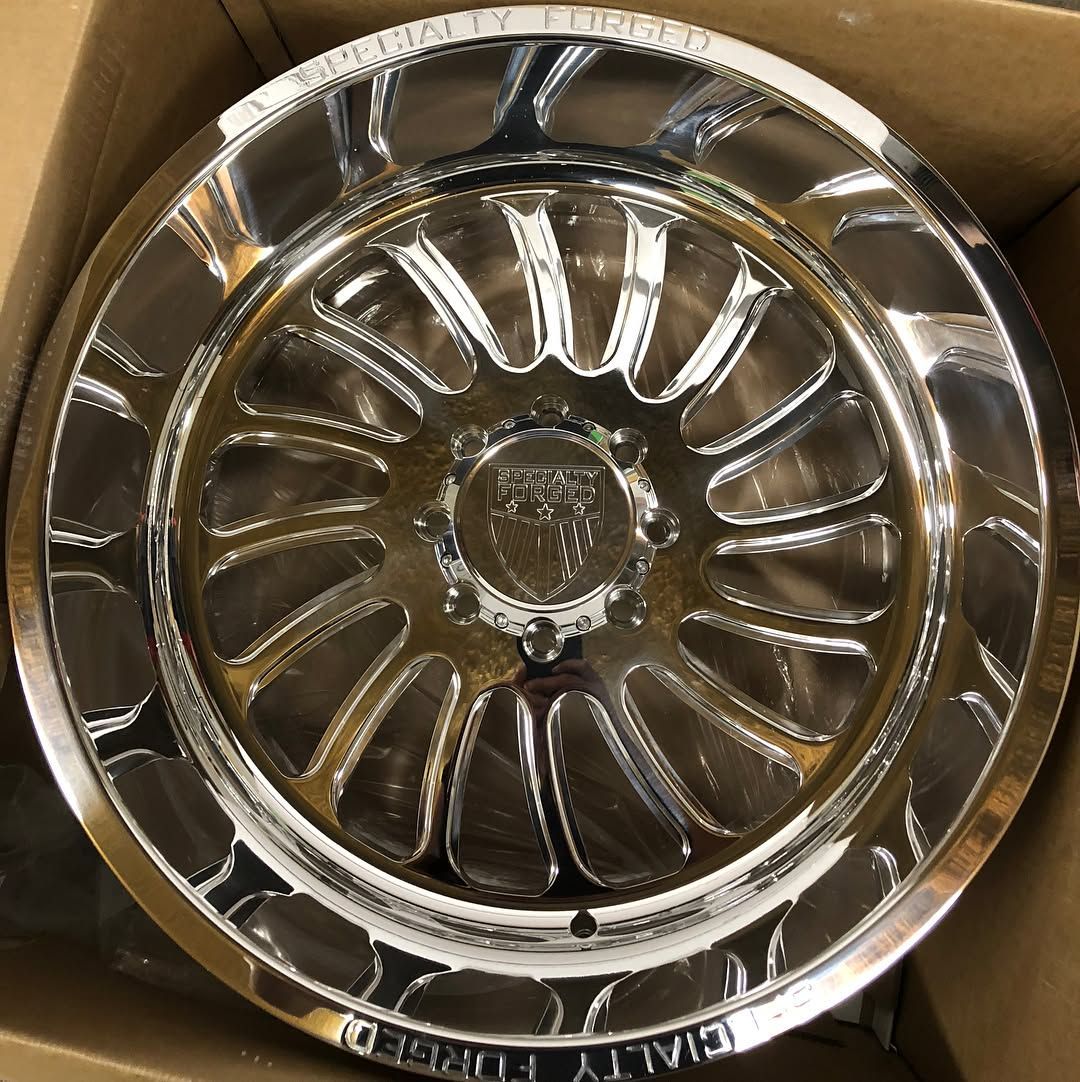 Chrome wheel rim in a cardboard box, viewed from above
