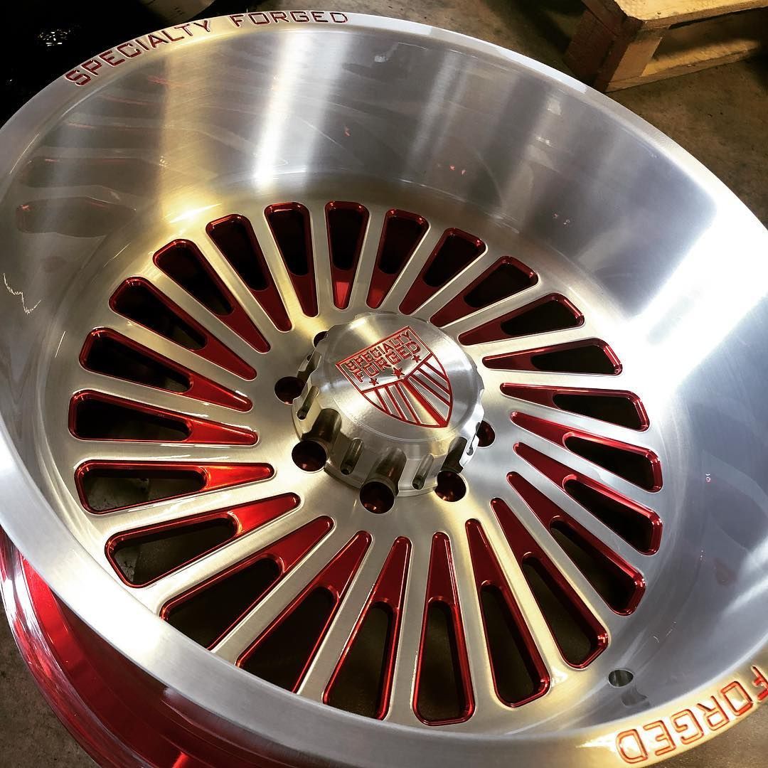 Close-up of a metal engine or fan cover with red slotted vents and a central logo