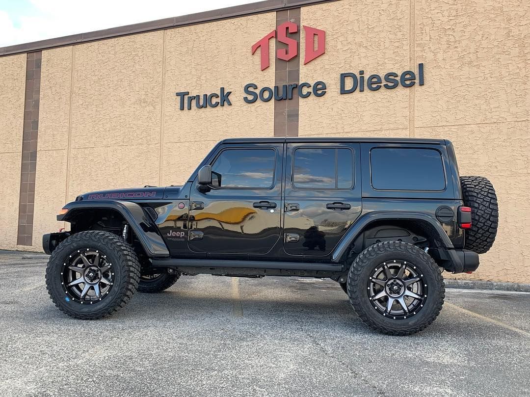 Black lifted Jeep SUV parked outside Truck Source Diesel building