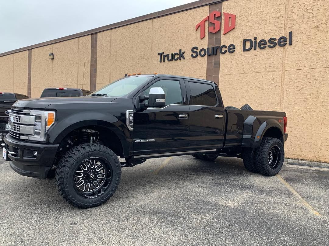 Black lifted pickup truck parked outside Truck Source Diesel building