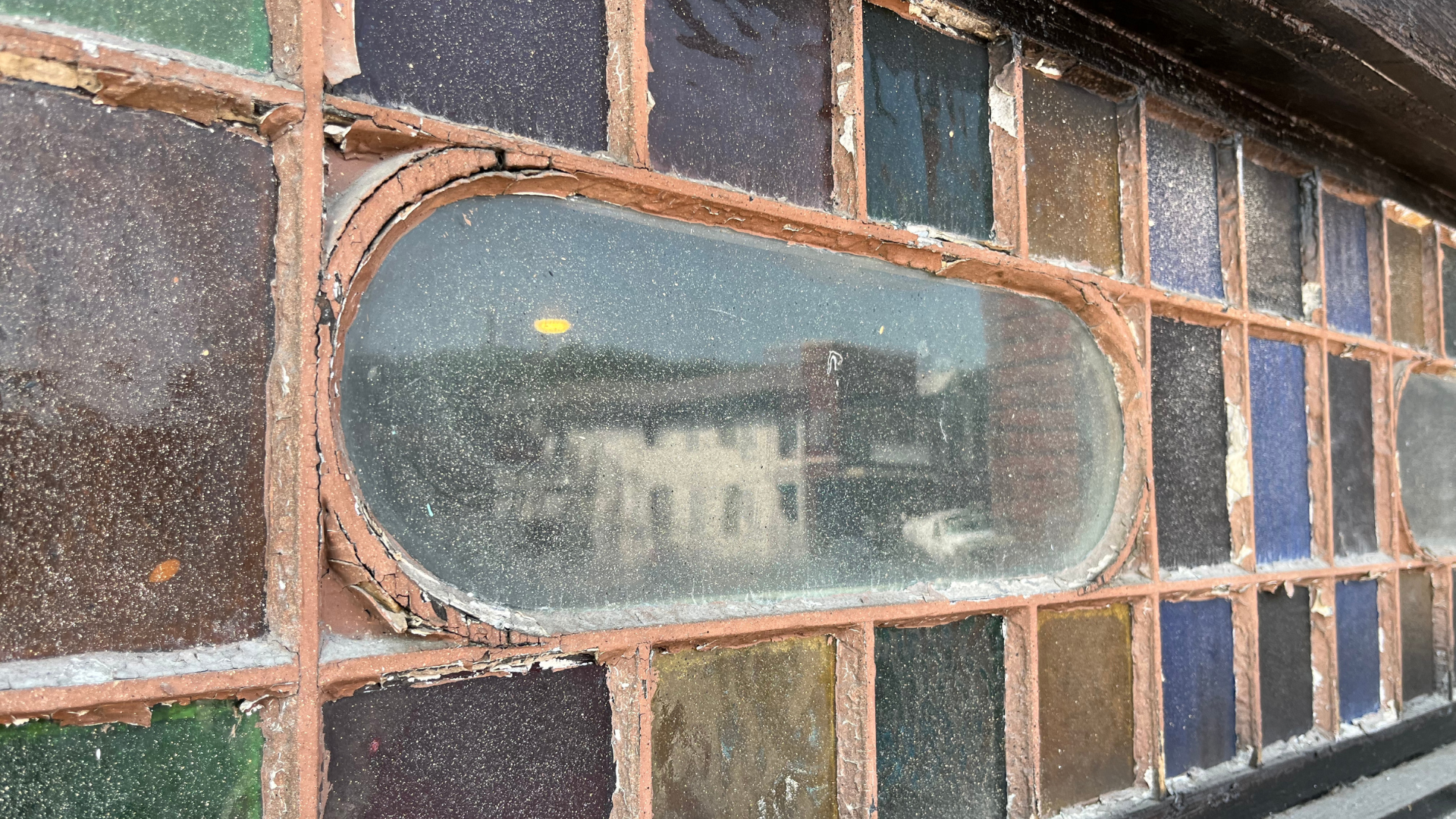A close up of a stained glass window on a building.