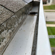 A close up of a gutter on the side of a roof.