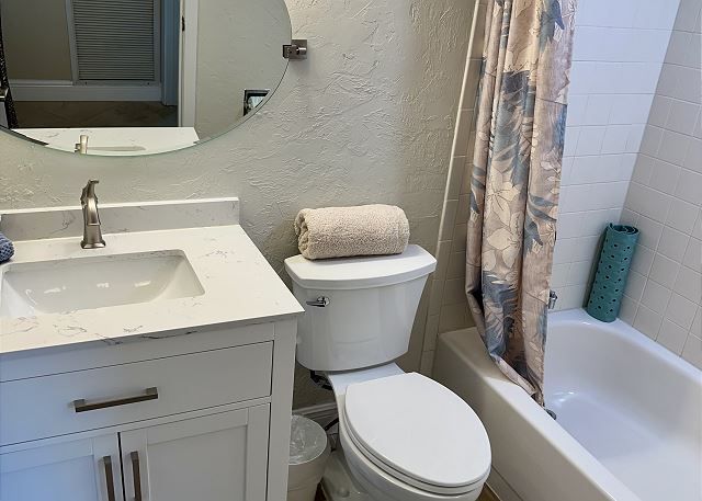 A bathroom with a toilet , sink and bathtub