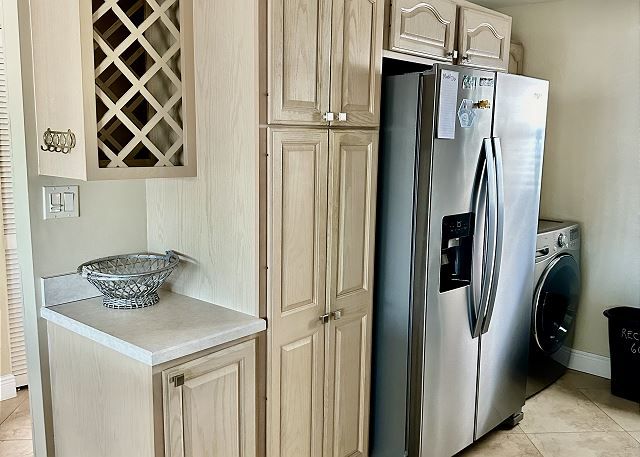 A kitchen with stainless steel appliances and white cabinets.