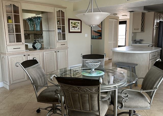 A dining room with a glass table and chairs