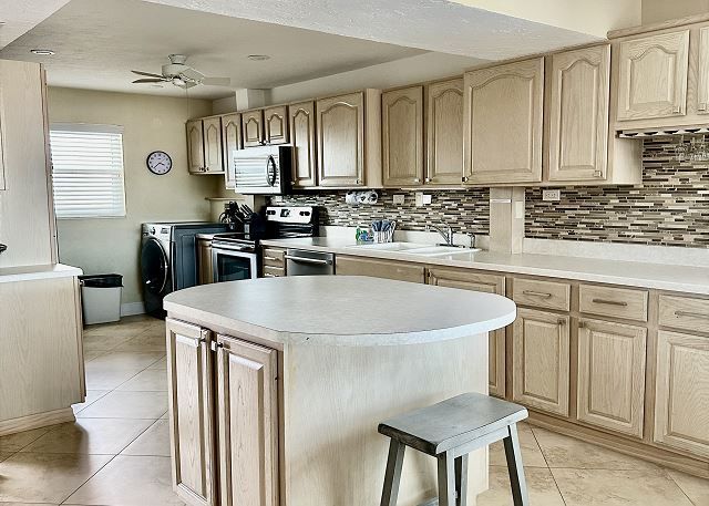 A kitchen with a large island in the middle of it.