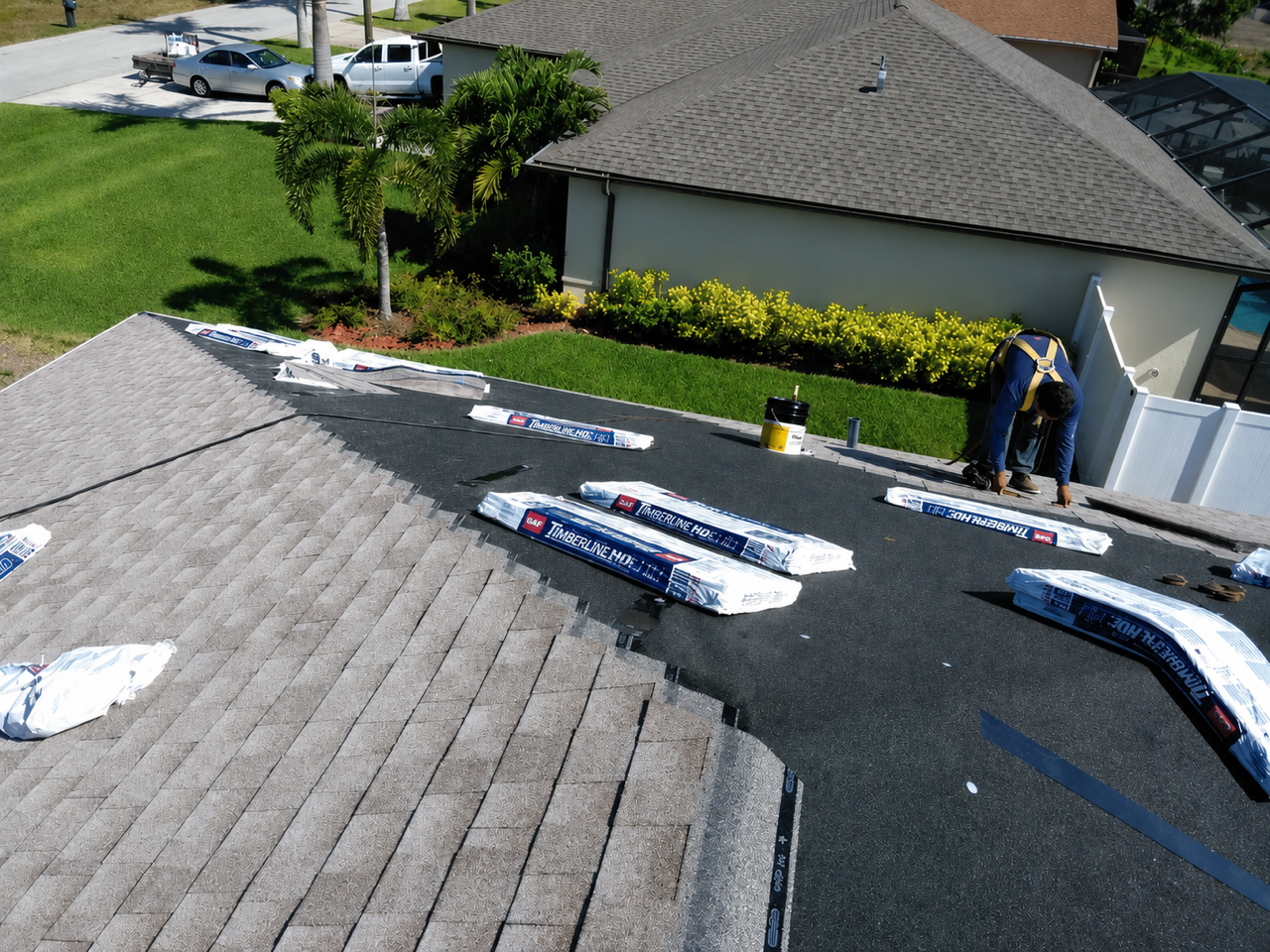White tiled roof with a peaked ridge and dark gray trim against a plain background